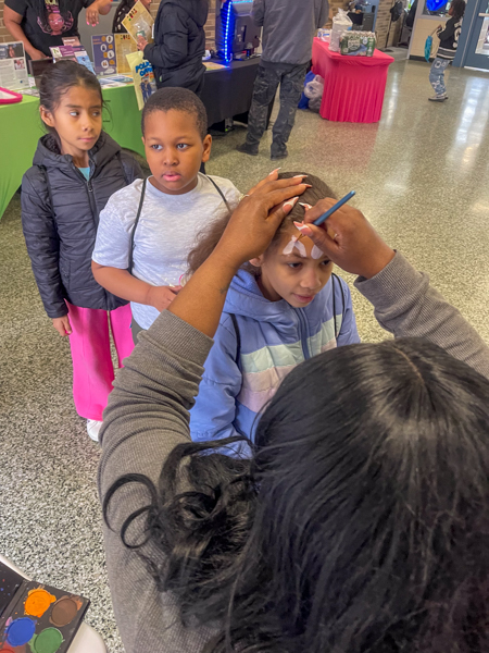 Young participants engaged in coloring book activities during Books and Breakfast