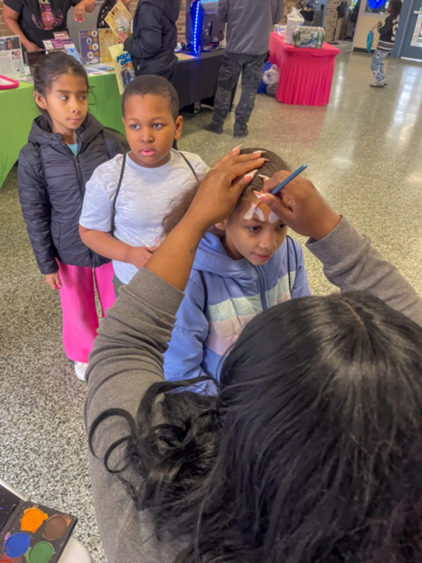Young participants engaged in coloring book activities during Books and Breakfast