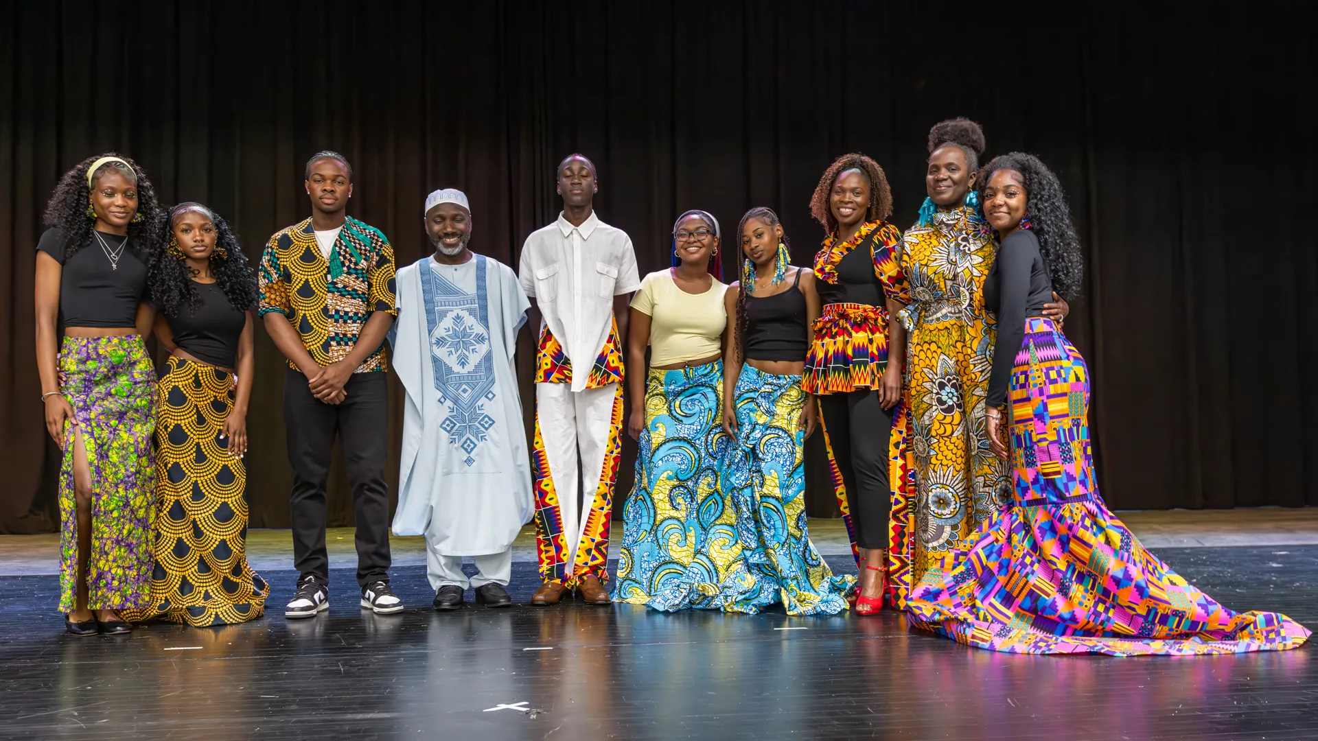 Stitch and Style group photo — students and mentors in their African-designed attire on stage