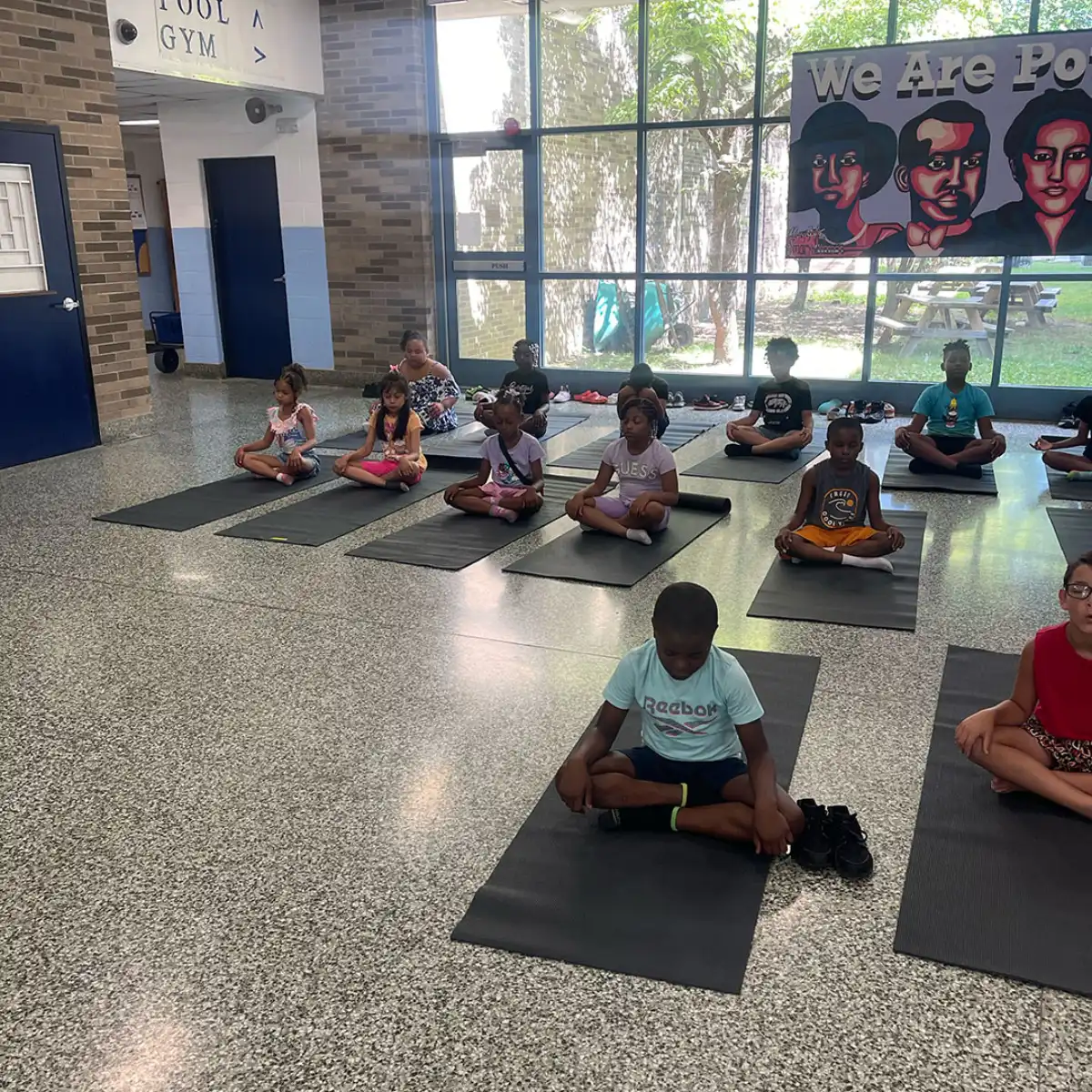 Children practicing yoga poses together during a ZenKids class